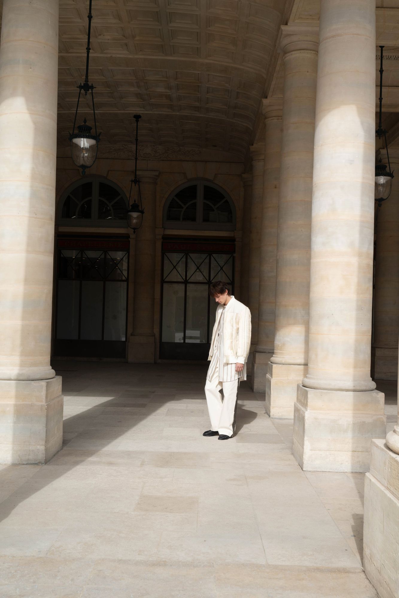 Editorial portrait beneath the Palais Royal colonnade
